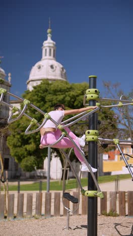 woman exercising on outdoor fitness equipment in a park