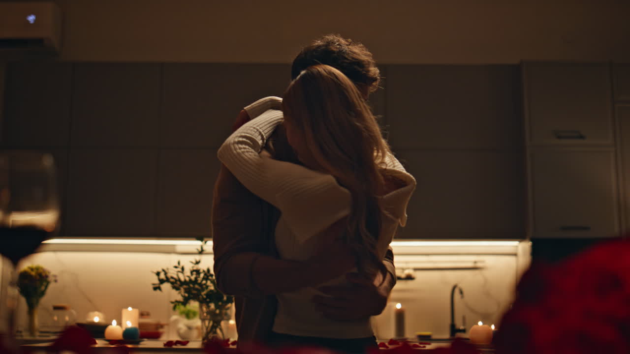 Tender lovers dancing dark kitchen closeup. Happy couple hugging on evening date