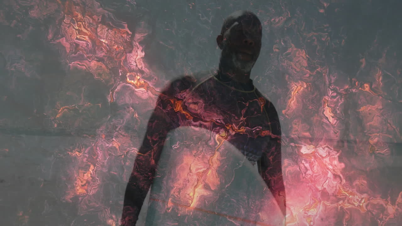 man standing facing forward in studio, with animated molten color flows driving technology concept