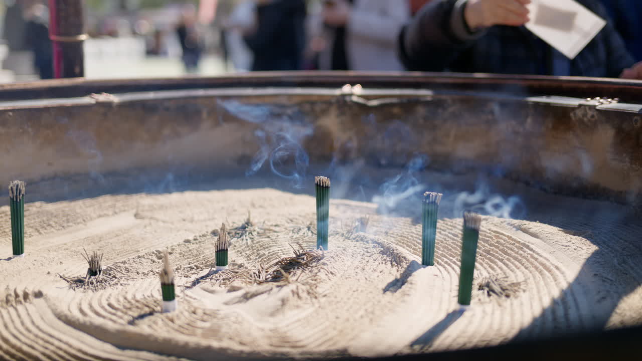 Incense burning on a jokoro at the Senso-ji temple in daylight in Tokyo, Japan