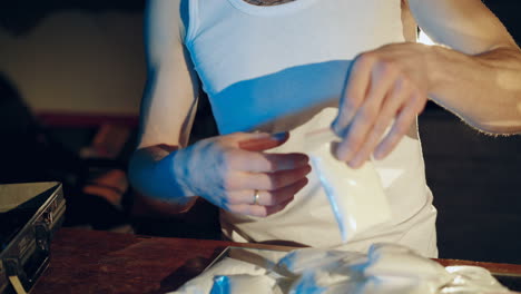 drug trafficker is packing drugs into suitcase. close-up. drug addiction. criminal business