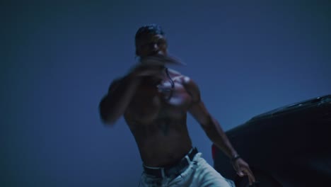 male hip-hop dancer does freestyle pop and lock moves.