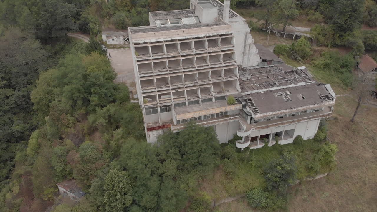 Abandoned hotel and outdoor pool in the middle of the mountains in autumn
