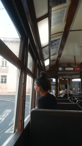 woman on a tram looking out the window