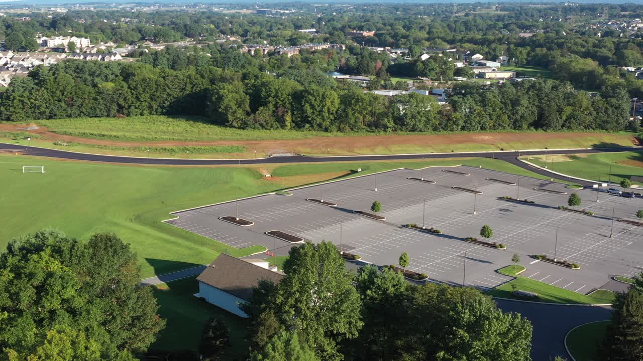 High aerial pan of housing neighborhood and farmland consumed for construction
