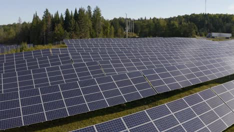 drone video of small solar farm in rural ontario with cars passing in the background