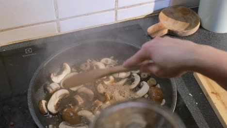 close up of fresh sliced mushrooms cooking in a pan for a delicious healthy recipe