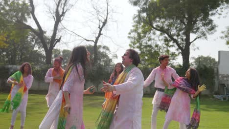 indian people celebrating holi festival in a park