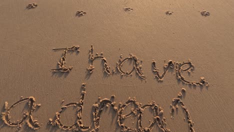 the sentence "i have a dream" is written on the sand beach