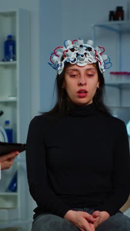 woman undergoing brain activity monitoring with eeg cap in a neuroscience laboratory