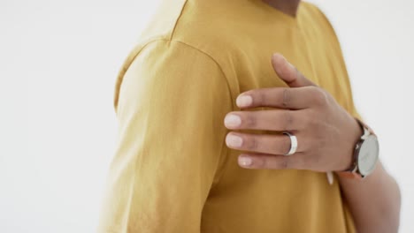 midsection of african american man wearing yellow t-shirt with copy space on white background