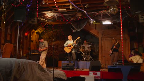 the camera travels up to a stage as a band plays