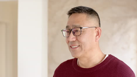 smiling man wearing glasses and red sweater enjoying festive holiday moment, copy space