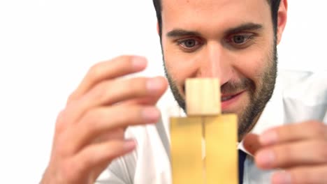 businessman playing with building blocks