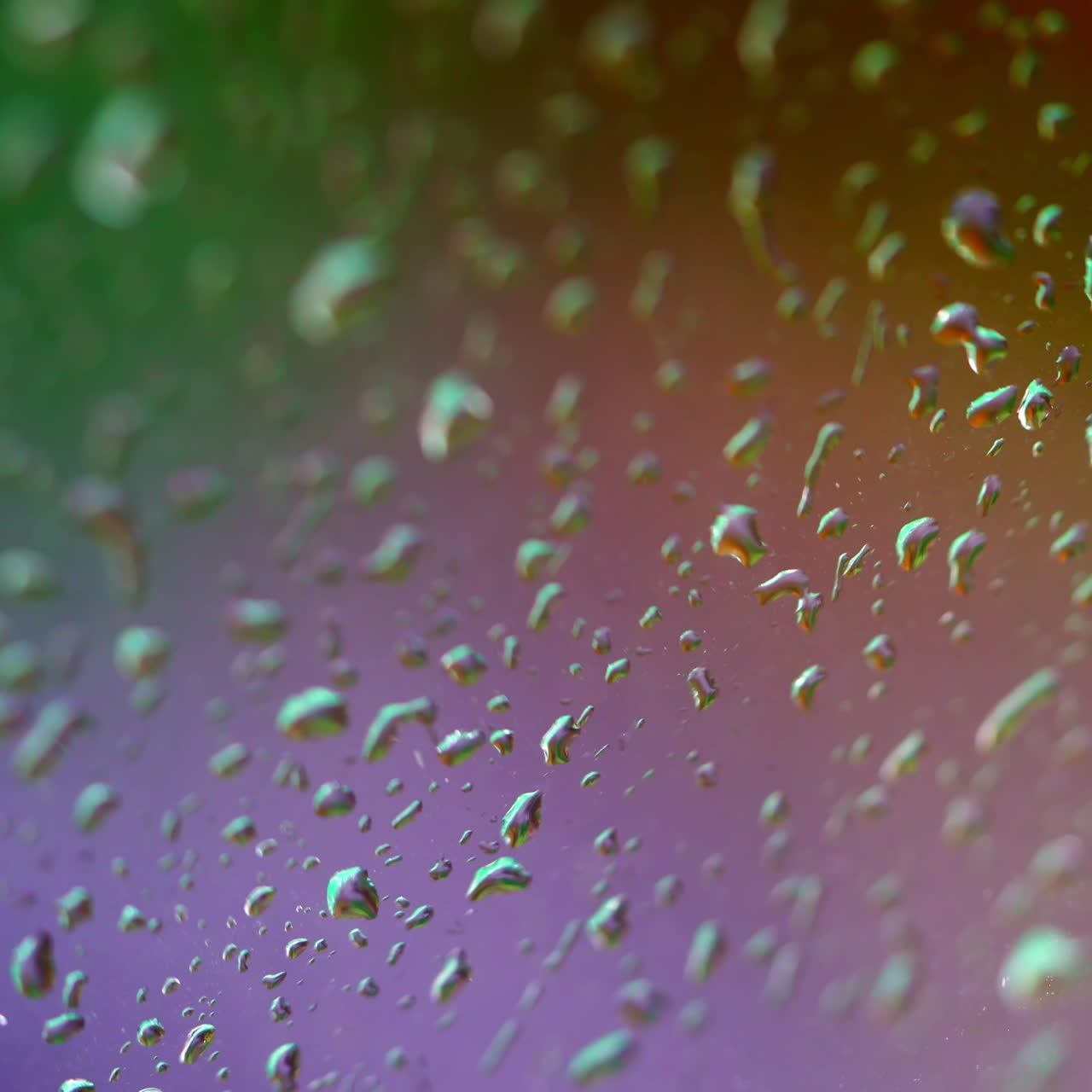 Colorful texture with water drops. Rain drops on window. Water droplets falling on glass in rainy weather. Close-up.