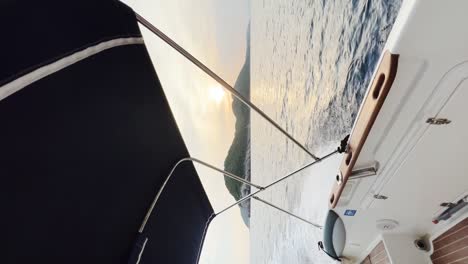 view from the stern of the boat going fast while leaving a trail of foam behind it with the kolocep island in the distance, croatia