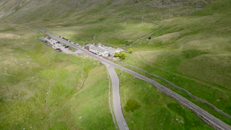 kirkstone pass summit with sunlight pools moving over landscape. old inn visible. lake district, cumbria, uk
