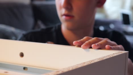 Young-Curly-Hair-Boy-Building-A-Shelf