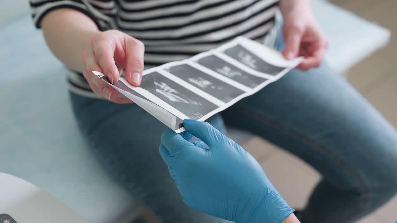 Patient holds scan printout while the female doctor explains results, providing interpretation. Both interact while discussing the medical images, highlighting the importance of clear communication