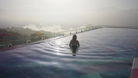 sexy asian woman relaxing in infinity pool of luxury hotel in taiwan