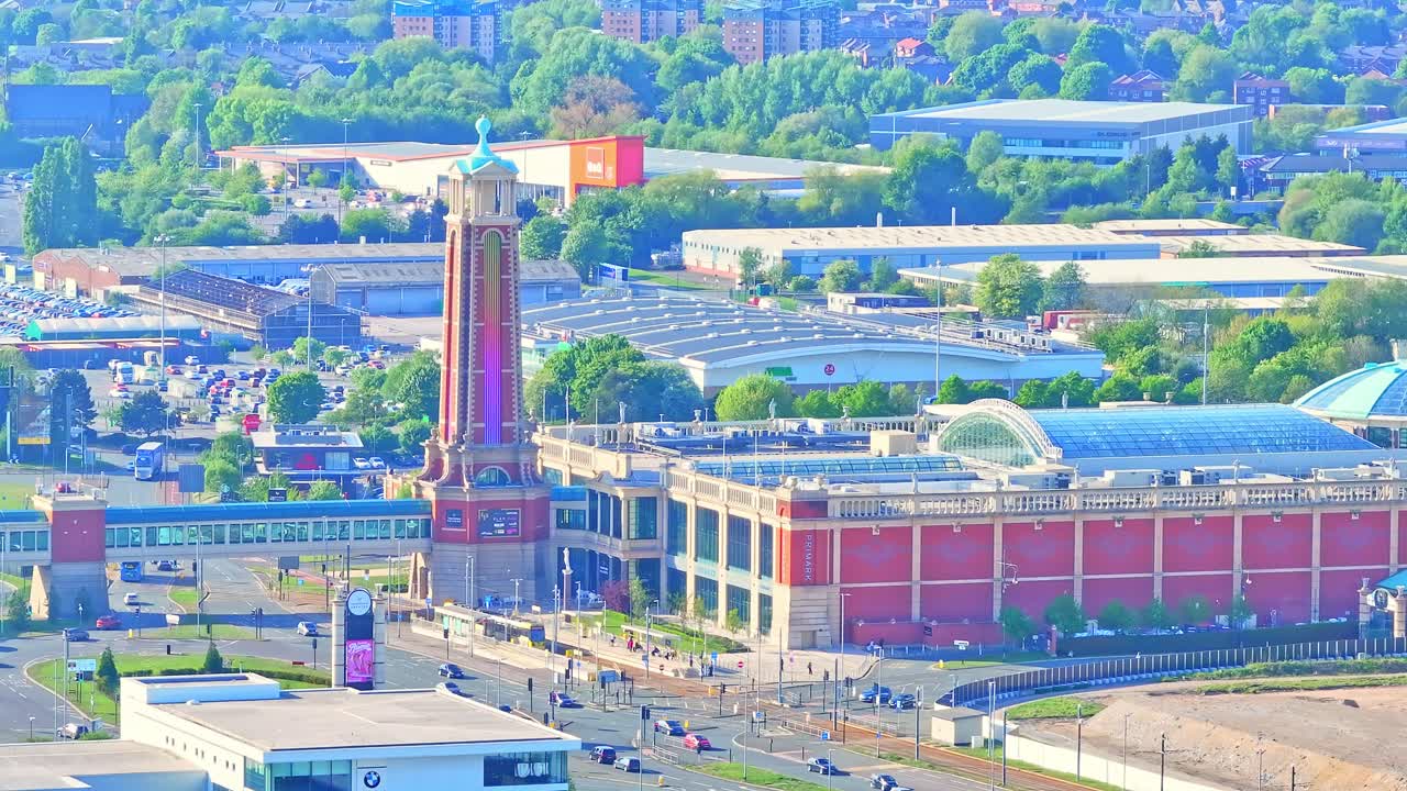 Orbit drone shot close to Trafford Centre large indoor shopping centre during the day in Trafford Park, Greater Manchester, England