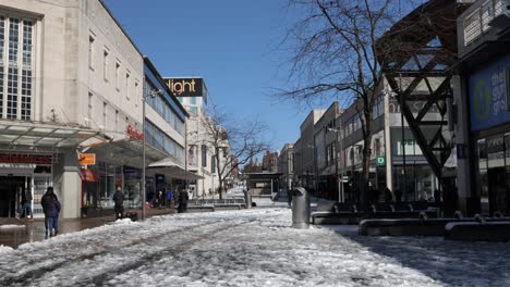 a snowy and sunny pedestrianised shopping street