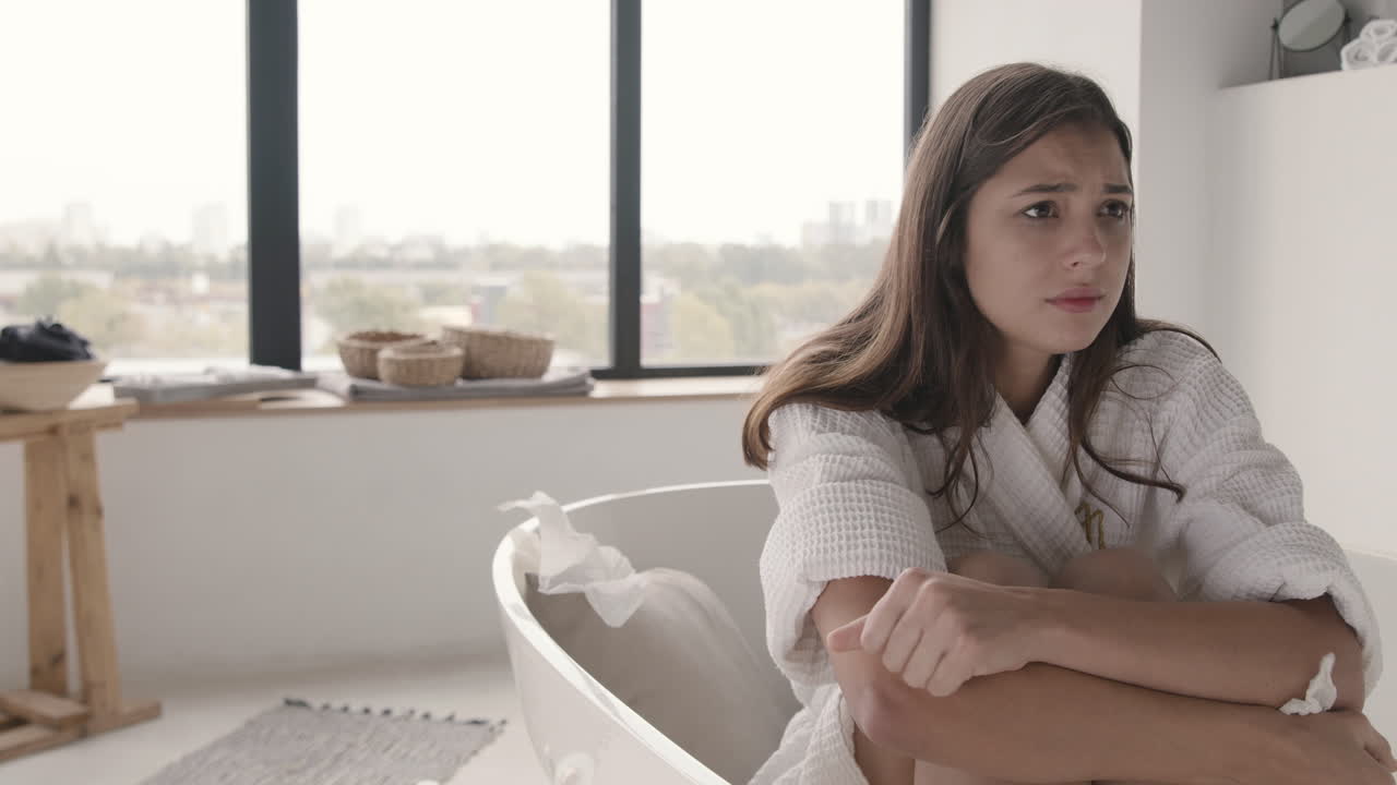 Sad Woman Crying While Sitting In The Bath In A Modern Bathroom At Home 1