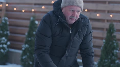 grandfather and granddaughter having fun in the snow