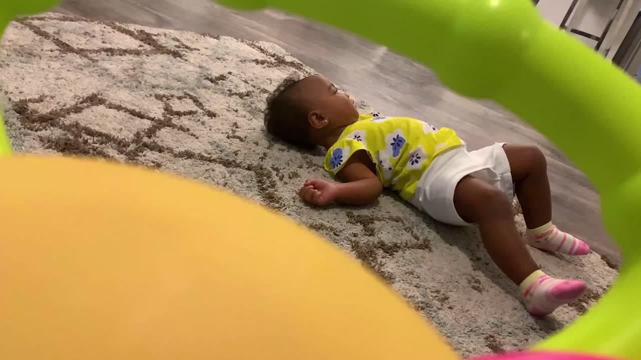 Bambino che rotola sul pavimento.