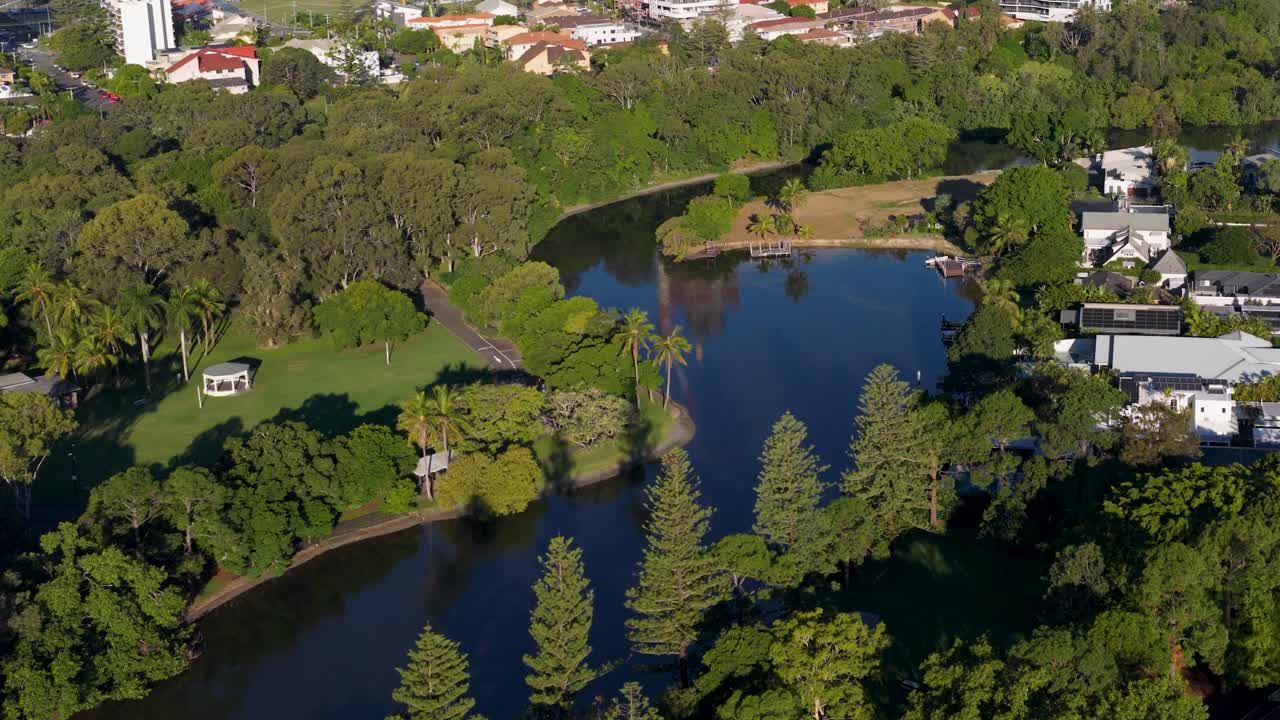 Aerial footage captures lush landscapes and winding waterways in Gold Coast, Australia, under bright daylight