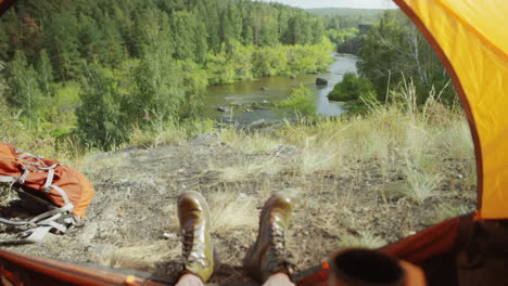 pov of tourist enjoying nature view with tea
