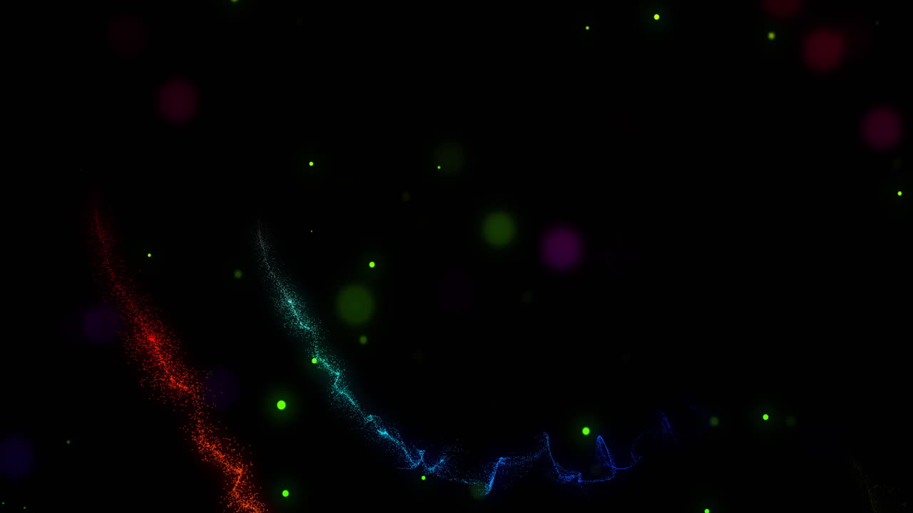 rastros rojos, amarillos y verdes de luz brillante que gotea girando sobre un fondo negro