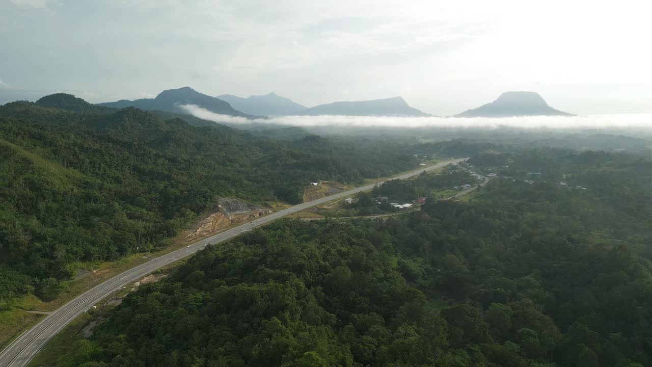 Beautiful Drone View Of Bau To Lundu Pan Borneo Highway During Morning Sunset With Mountain And Valley, Green Forest,Sarawak, Borneo.