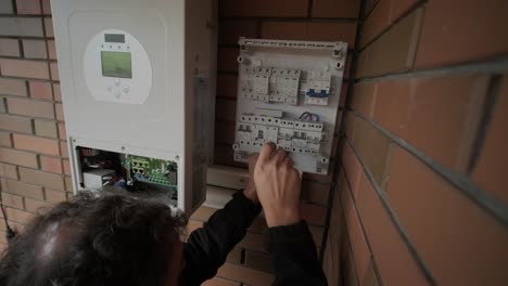 an electrician installing an inverter in a home. the image shows technical skill, modern tools, and attention to safety in electrical work