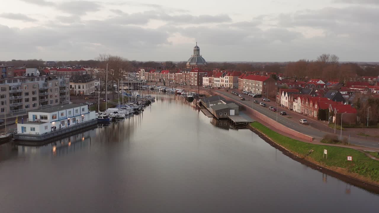 View from a dyke to a view of the marina in the historical center of Middelburg. Drone shot,