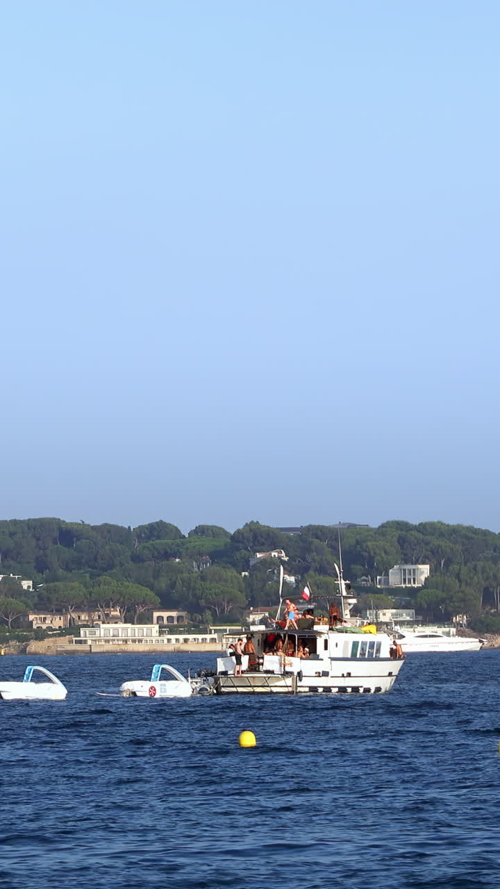 People relaxing in a white boat on the sea in Golfe-Juan, France