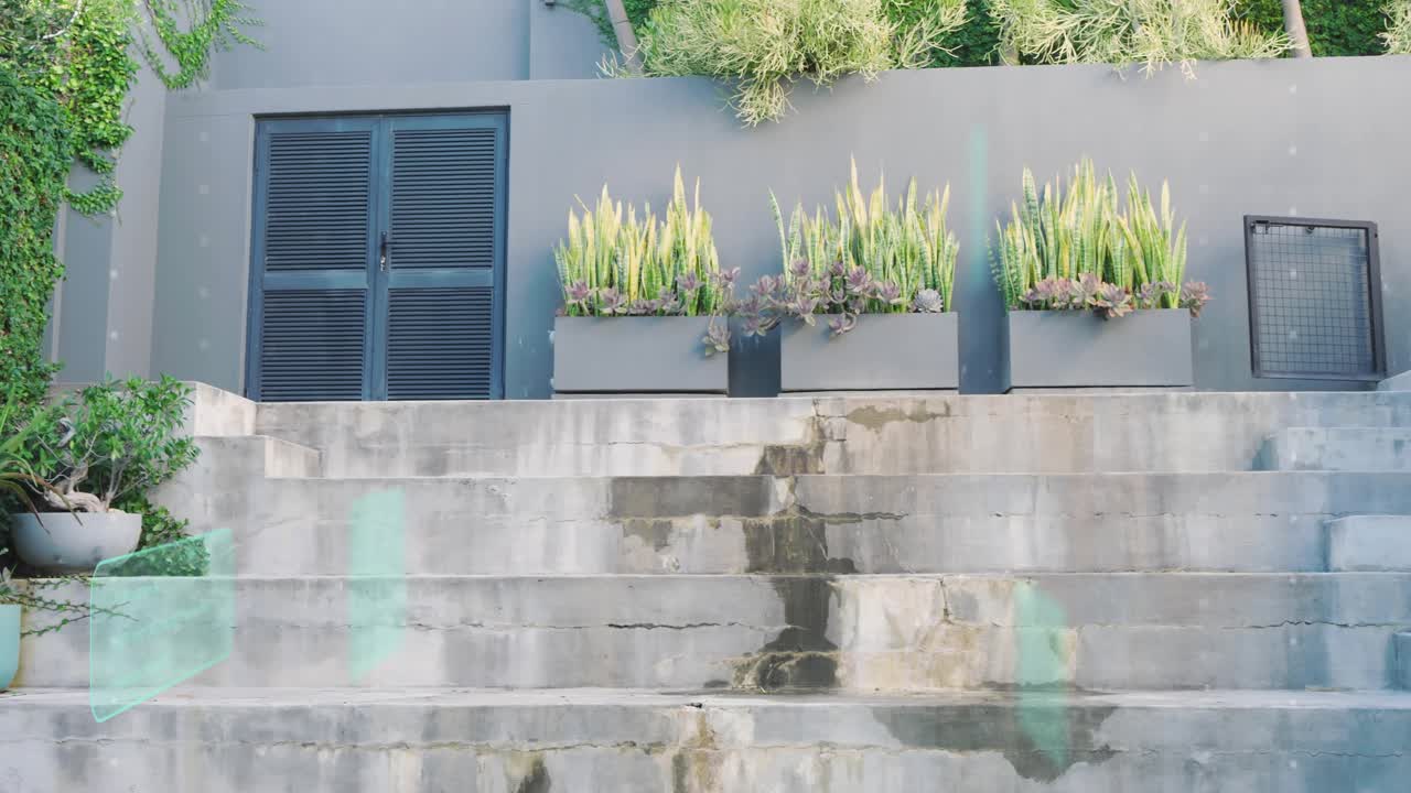 On play camera rising to show louver door and planters on steps while teal streaks drifting