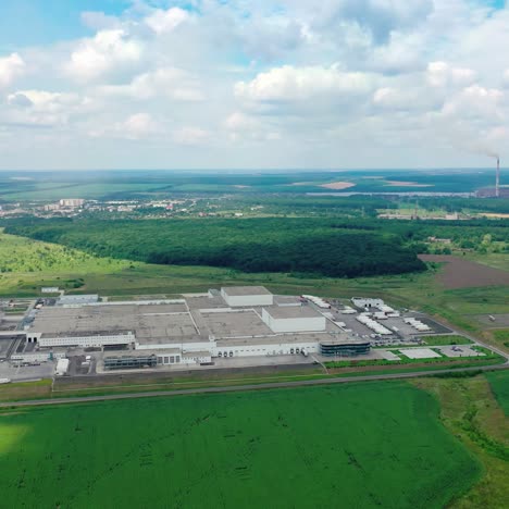 panoramic view of industry in the countryside. factory on green field. industrial plant on nature background. aerial view