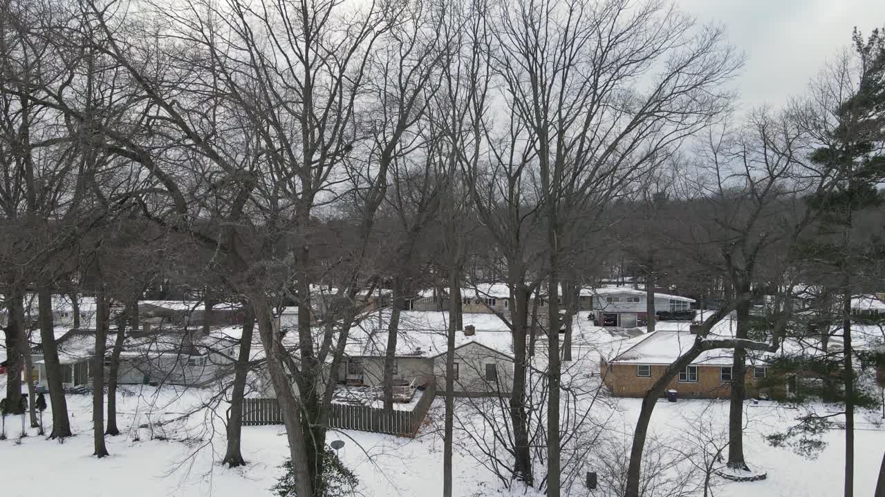 2021년 12월에 신선한 눈이 내린 후 미시간 호수 근처의 수목선 위로 부드럽게 떠오르는 드론