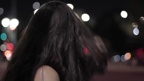 Close-up-Shot-Of-A-Young-Black-Haired-Woman-Waiting-At-The-Side-Of-The-Road