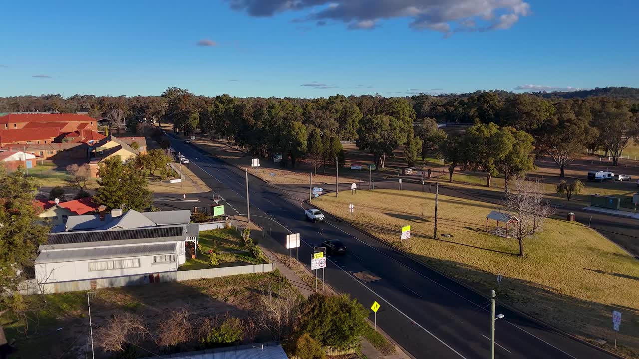 Vehicle travels along tree-lined streets in residential area