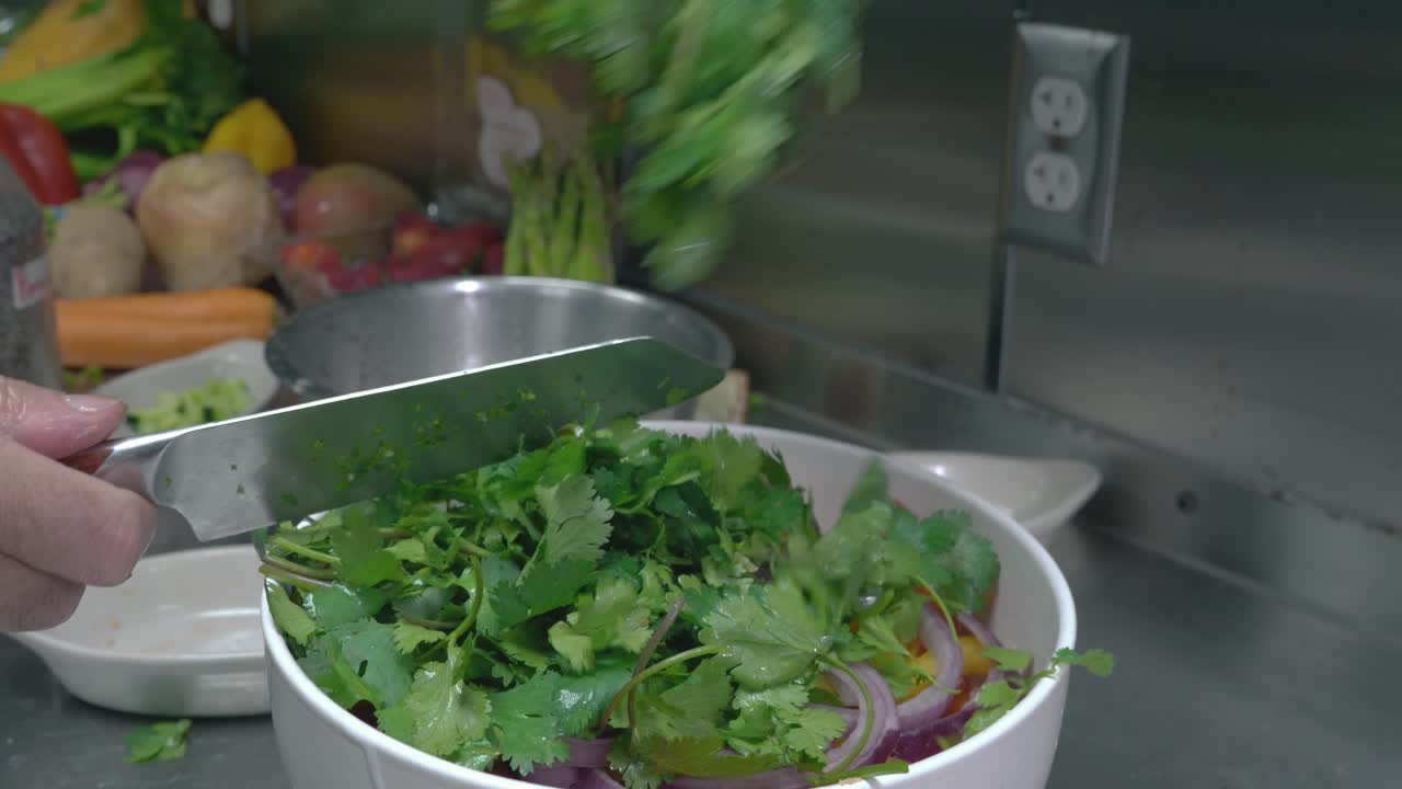 Up close shot of chef hands chopping up cilantro