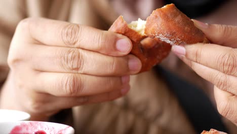 person eating a donut