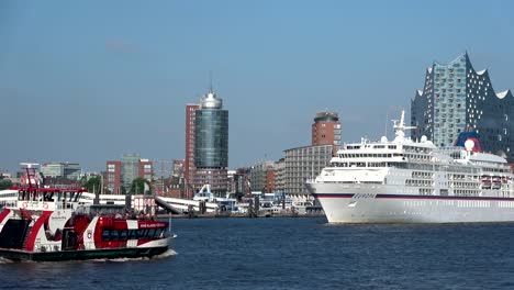 cruise liner in hamburg on departure, elbe and cityscape,