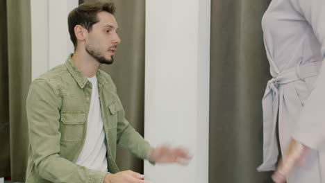 man and woman arguing in a fitting room