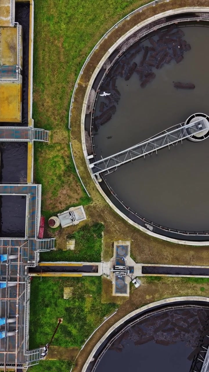 View of water treatment facility showing tanks and pipes in operation