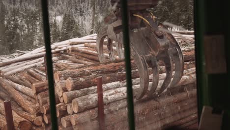 first person pov blue collar tradesman operates industrial timber logging manipulator arm claw tractor from inside cabin with joystick-3