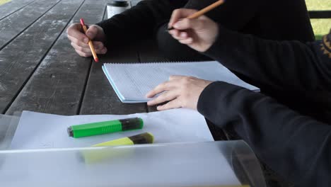 men doing homework at bench