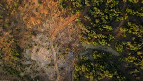 Aerial-footage-of-deforested-landscape-next-to-forested-one-with-a-river-full-of-life-and-biodiversity