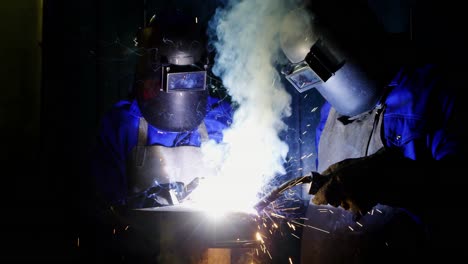 welders welding a metal